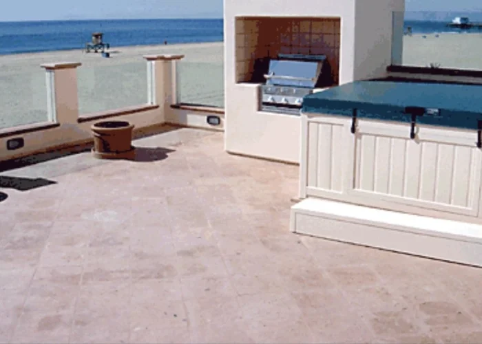 Balcony with a hot tub against a blue tiled wall